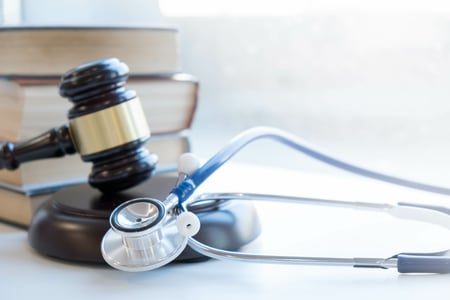 gavel and books next to a stethoscope 